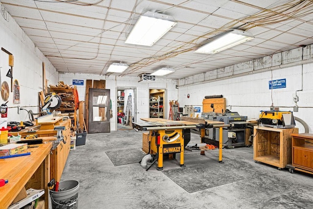 miscellaneous room featuring concrete floors and a workshop area