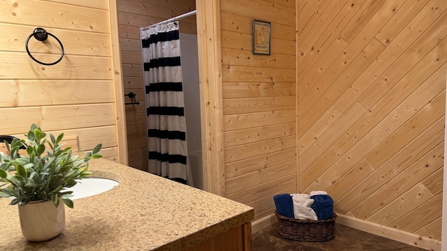 bathroom featuring wooden walls and walk in shower