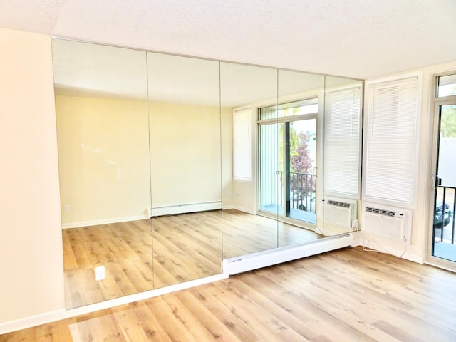 closet featuring a baseboard radiator and a wall unit AC