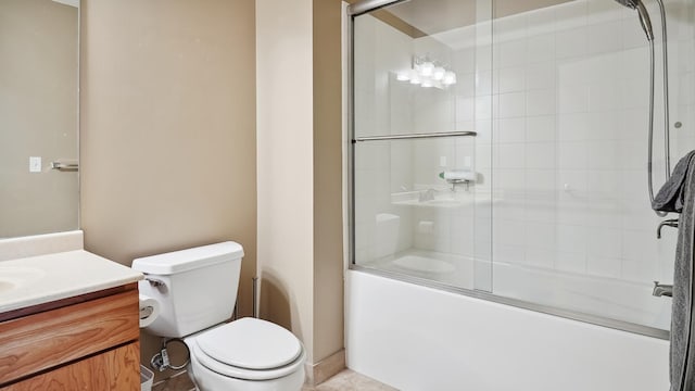 bathroom featuring toilet, shower / bath combination with glass door, and vanity