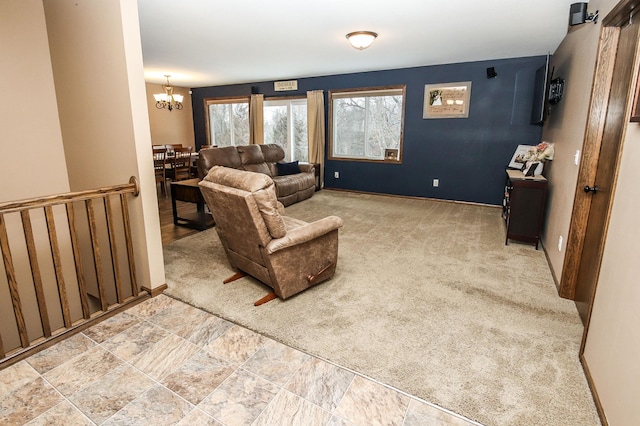 carpeted living room with a chandelier