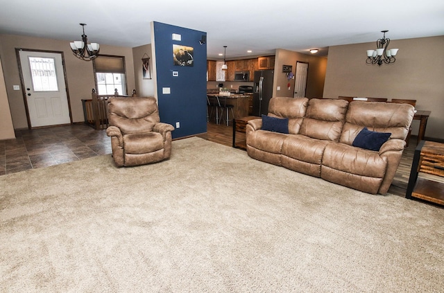 living room featuring a chandelier and dark carpet