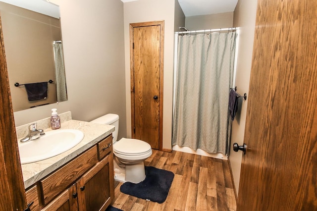 bathroom featuring vanity, toilet, and hardwood / wood-style floors