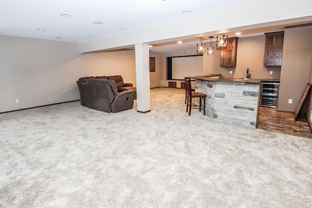 carpeted living room featuring wine cooler and indoor bar