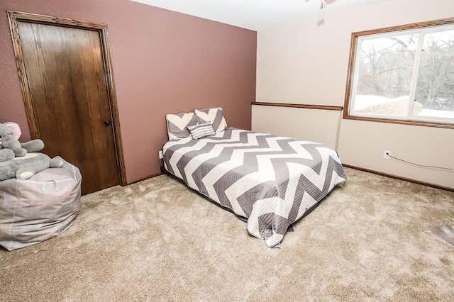 bedroom featuring light colored carpet and a closet