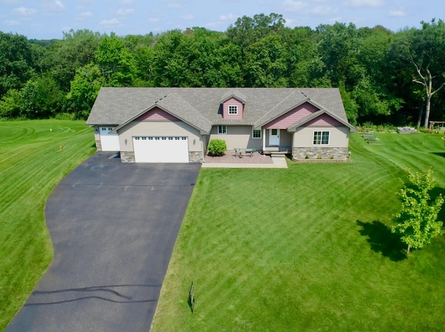 view of front of house featuring a garage and a front lawn