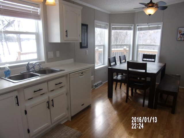 kitchen with white cabinetry, dishwasher, sink, light wood-type flooring, and a textured ceiling