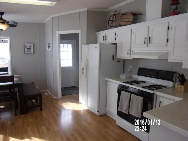 kitchen with white cabinetry, light wood-type flooring, range with gas cooktop, and a textured ceiling