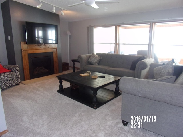 living room featuring ceiling fan and carpet flooring