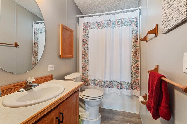 full bathroom with toilet, shower / tub combo, a textured ceiling, vanity, and hardwood / wood-style floors