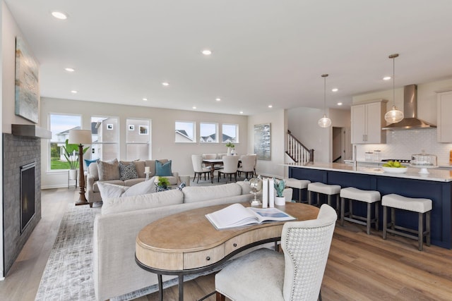 dining area with a fireplace and light hardwood / wood-style flooring