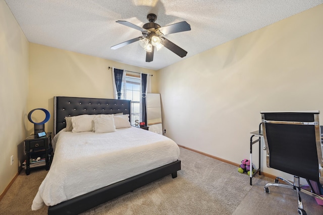 bedroom with ceiling fan, light carpet, and a textured ceiling