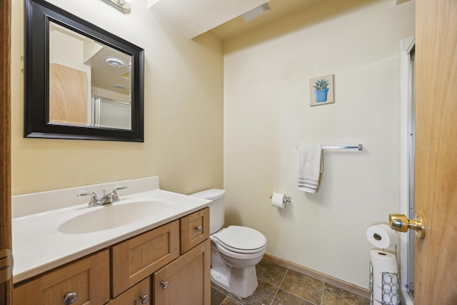 bathroom featuring vanity and toilet