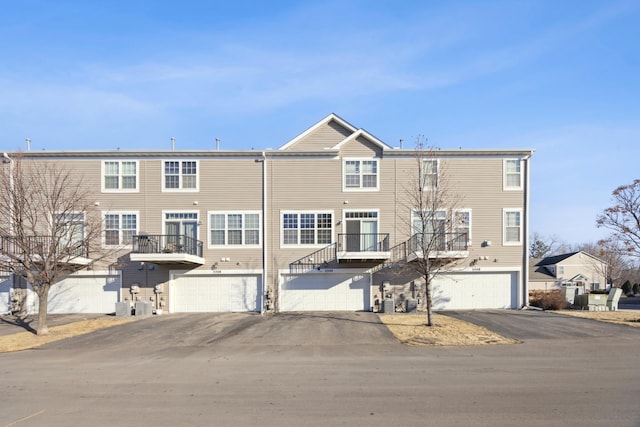 view of front of property with central AC unit and a garage