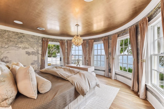 20100 Lakeview Ave, Deephaven, MN 55331 - bedroom featuring crown molding, multiple windows, a chandelier, wallpapered walls, and light wood-style flooring