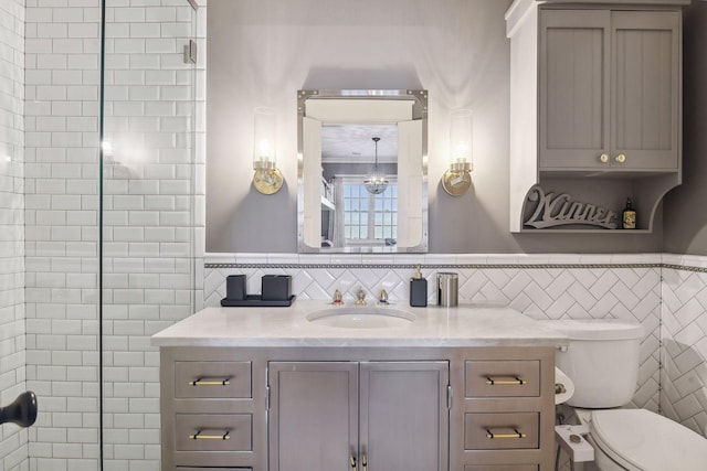 20100 Lakeview Ave, Deephaven, MN 55331 - bathroom with tile walls, vanity, tiled shower, and a wainscoted wall