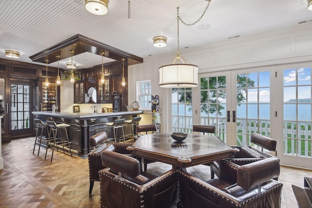 20100 Lakeview Ave, Deephaven, MN 55331 - dining room with a water view, wet bar, french doors, and ornamental molding