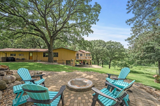 view of patio / terrace featuring grilling area, a fire pit, and a deck