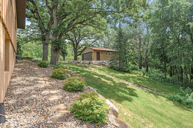 view of yard with an outdoor structure and a garage