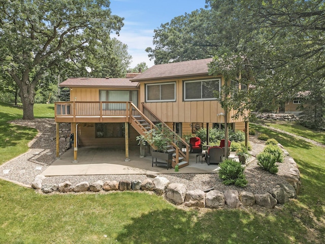 rear view of property with a wooden deck, a lawn, stairway, and a patio area