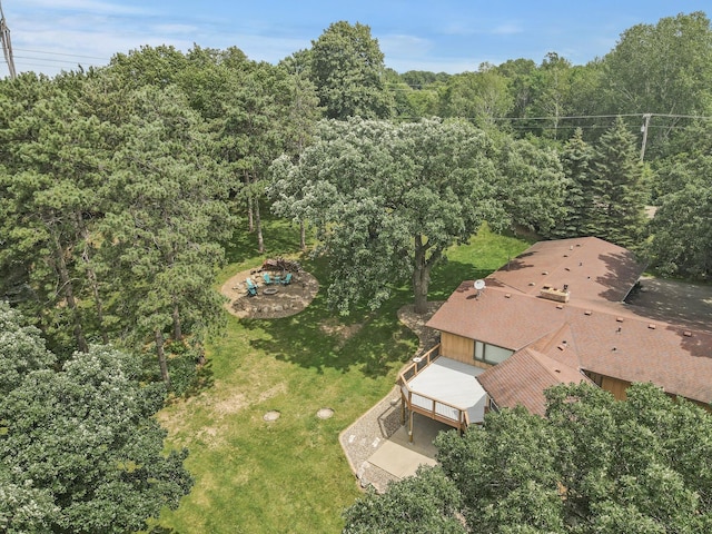 bird's eye view with a wooded view