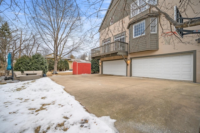 snow covered property with a garage