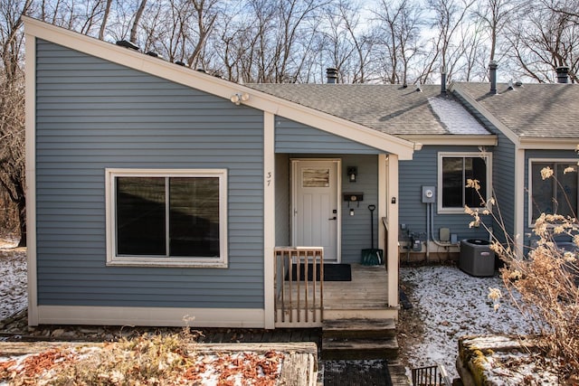 view of front of home with a wooden deck and central AC