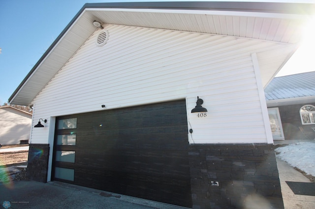 view of side of home with a garage