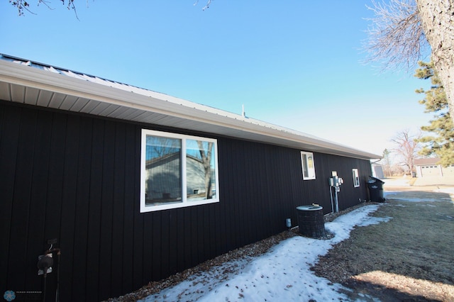 view of snowy exterior featuring central AC