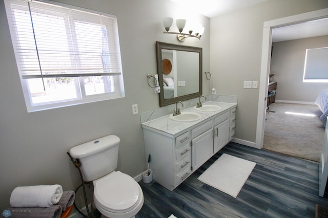 bathroom featuring vanity, toilet, and wood-type flooring