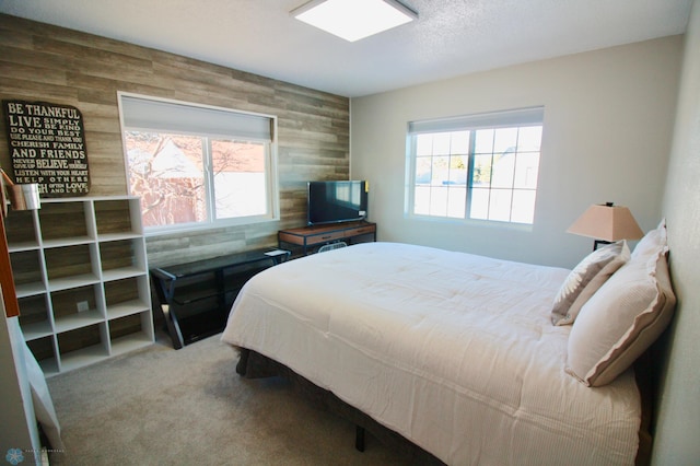 bedroom featuring multiple windows, carpet flooring, and a textured ceiling