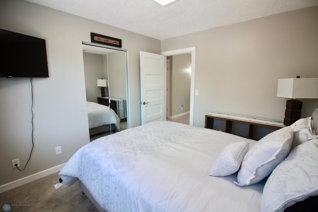 bedroom featuring a closet, a textured ceiling, and carpet flooring