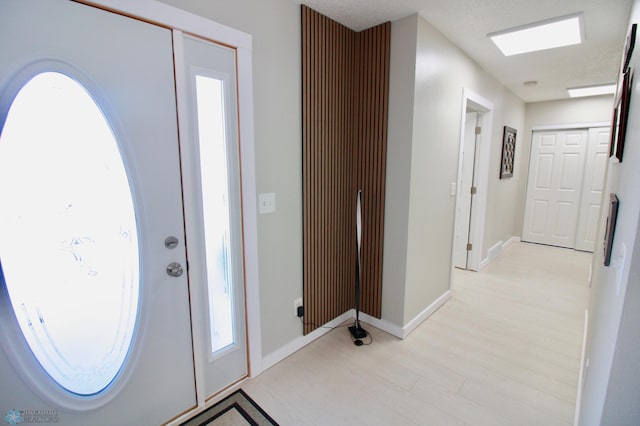 foyer entrance with light hardwood / wood-style floors