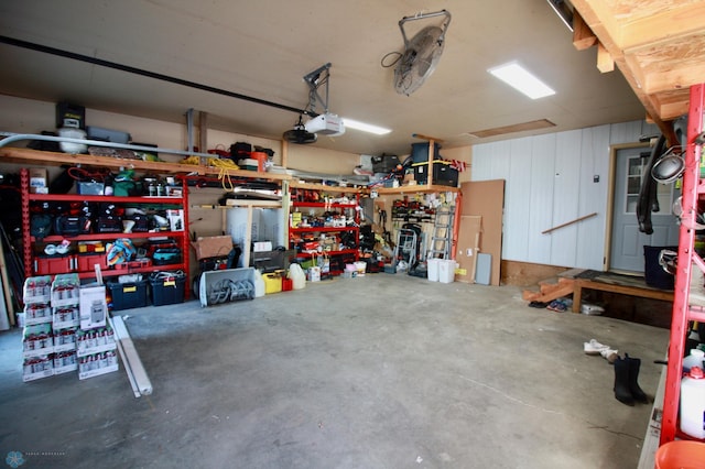 garage featuring a garage door opener and a workshop area