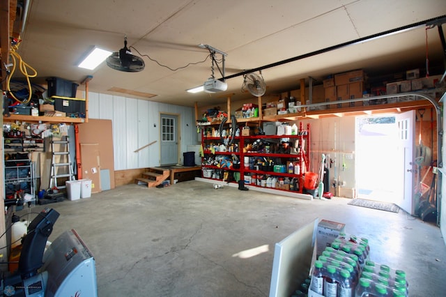 garage featuring a garage door opener and a workshop area