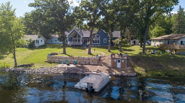 view of dock featuring a water view and a lawn