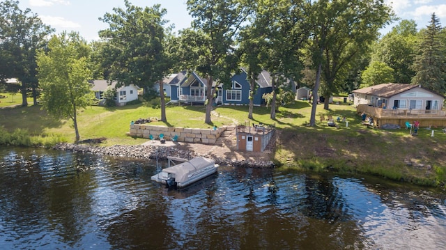 view of dock featuring a water view and a yard