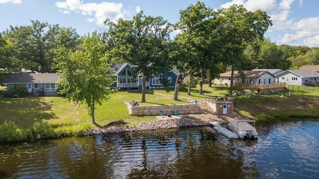 dock area with a water view and a yard