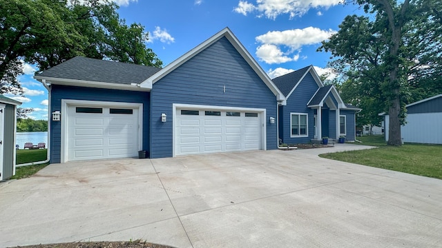 view of front of property with a garage and a front lawn