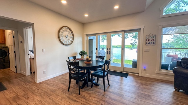 dining space featuring hardwood / wood-style floors, washer / clothes dryer, and french doors