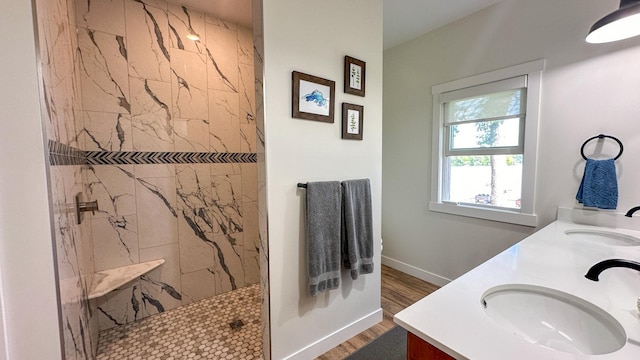 bathroom featuring vanity, hardwood / wood-style flooring, and tiled shower