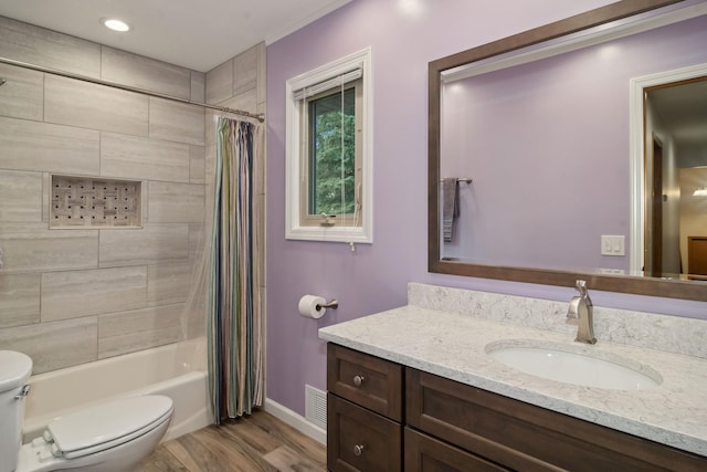 full bathroom featuring wood-type flooring, vanity, shower / bathtub combination with curtain, and toilet