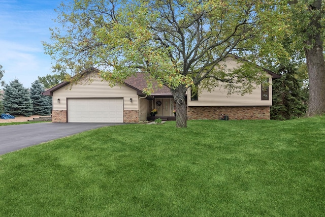 view of front of property featuring a garage and a front yard