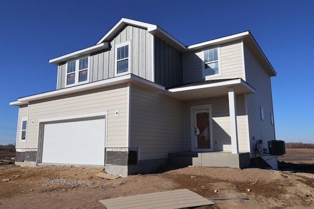 view of front of property featuring a garage and central AC unit