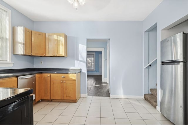 kitchen with light tile patterned floors and stainless steel appliances