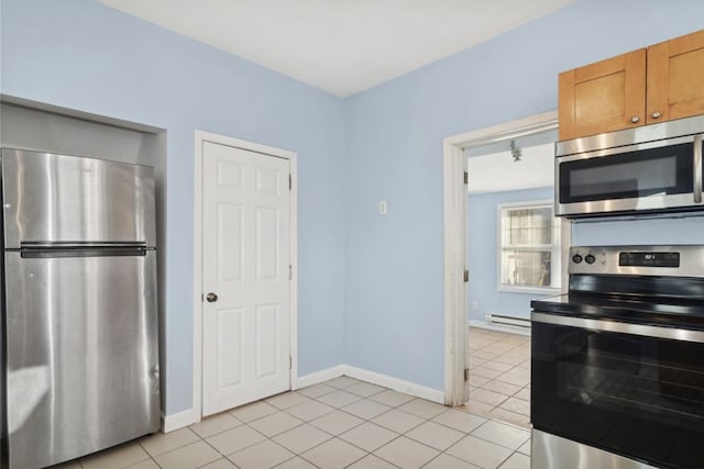 kitchen with light tile patterned floors, stainless steel appliances, and a baseboard heating unit