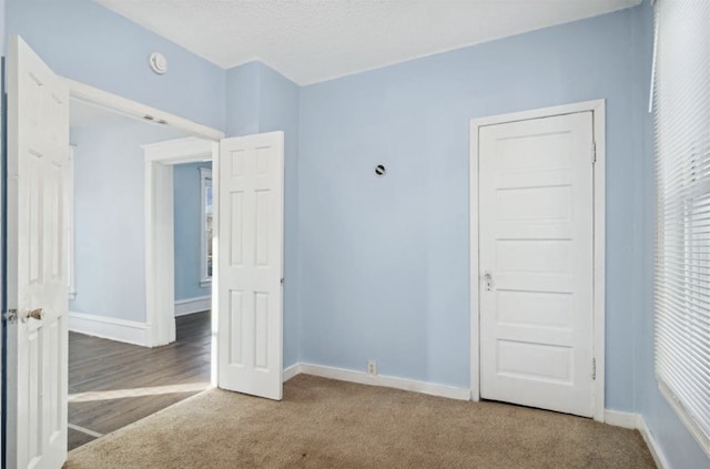 unfurnished bedroom with carpet flooring and a textured ceiling