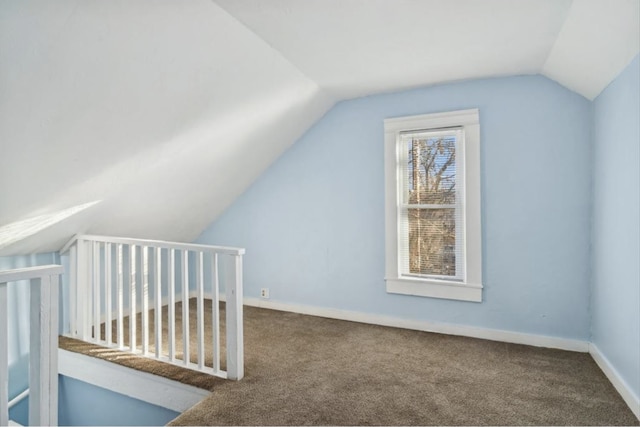 additional living space with lofted ceiling and carpet flooring