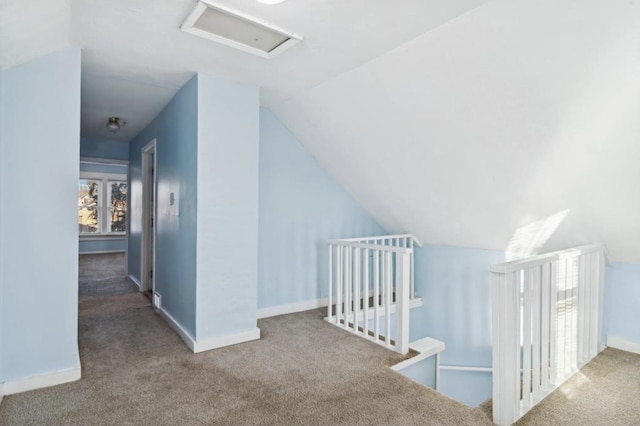 additional living space featuring lofted ceiling and carpet flooring