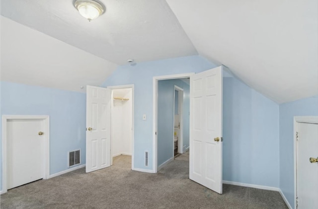 additional living space featuring lofted ceiling and carpet floors